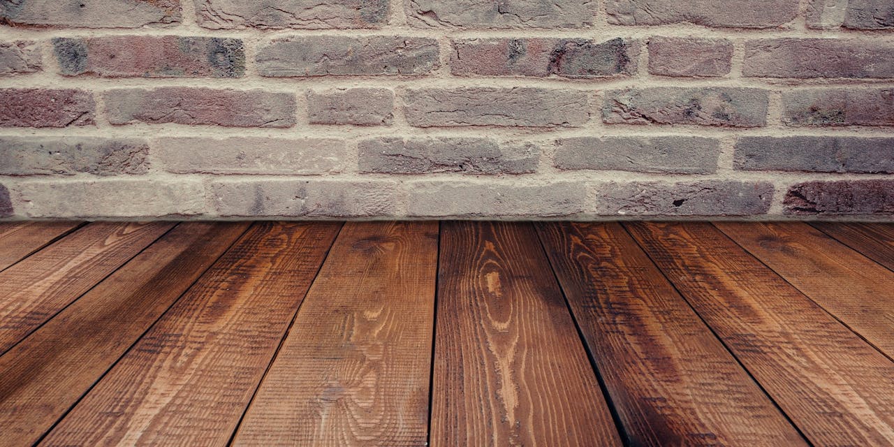 Pealeht Stylish vintage brick wall background complemented by a rustic wooden floor.